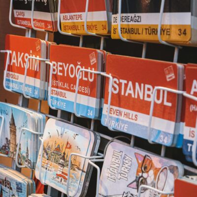 Postcards Display on White Racks Hanging on a Wall